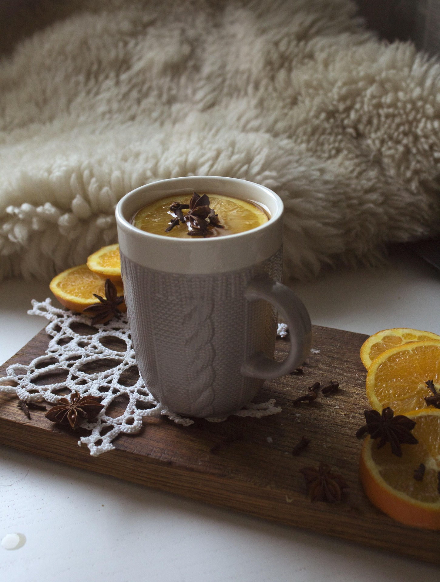 Mug of tea with orange slices and spices
